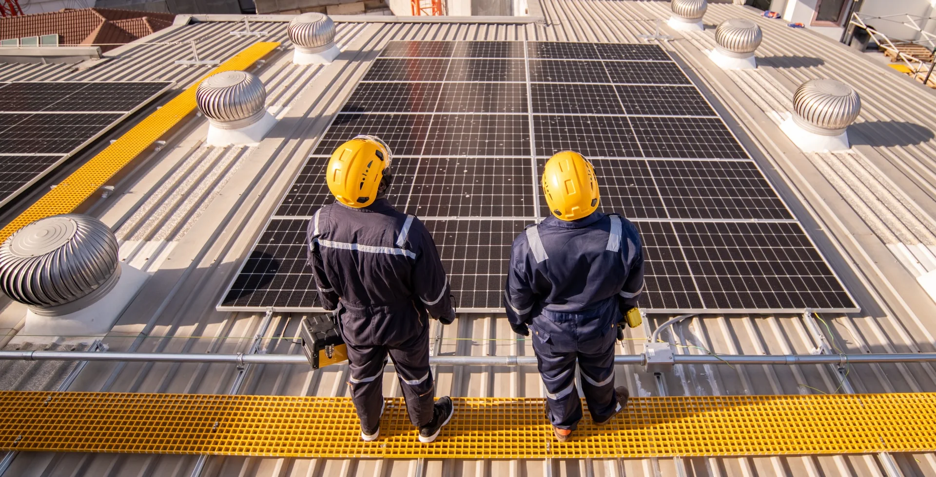 Experienced solar installation team inspecting a commercial rooftop photovoltaic system in South Africa