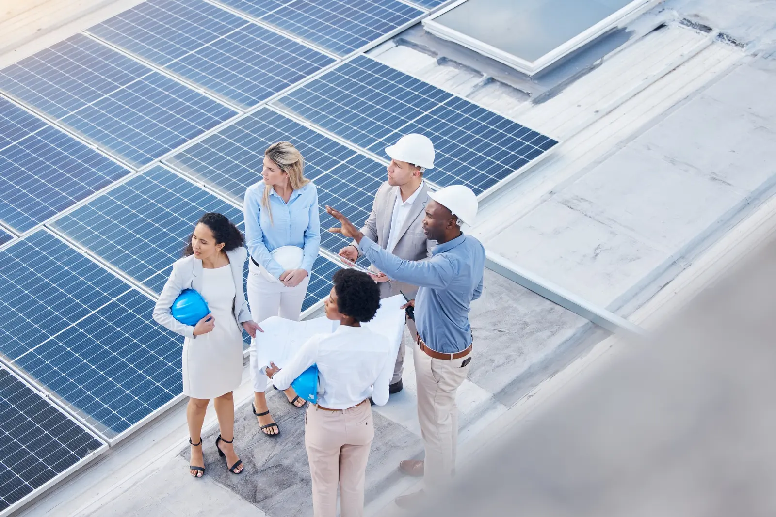 Commercial solar engineering team planning a rooftop photovoltaic installation