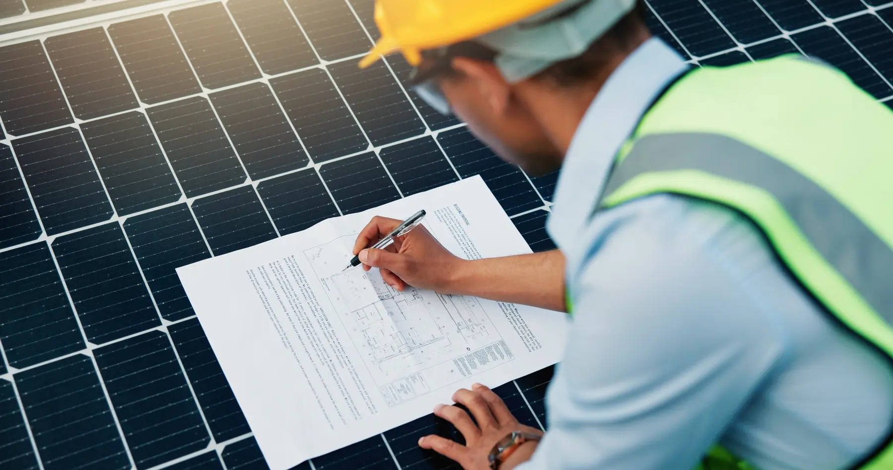 Solar engineer preparing a photovoltaic and battery project design for finance assessment