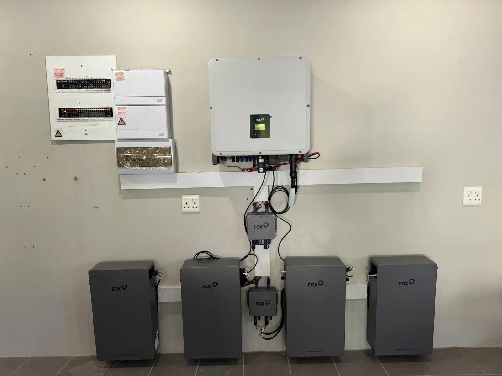 Installed FoxESS hybrid inverter with four modular batteries and electrical protection