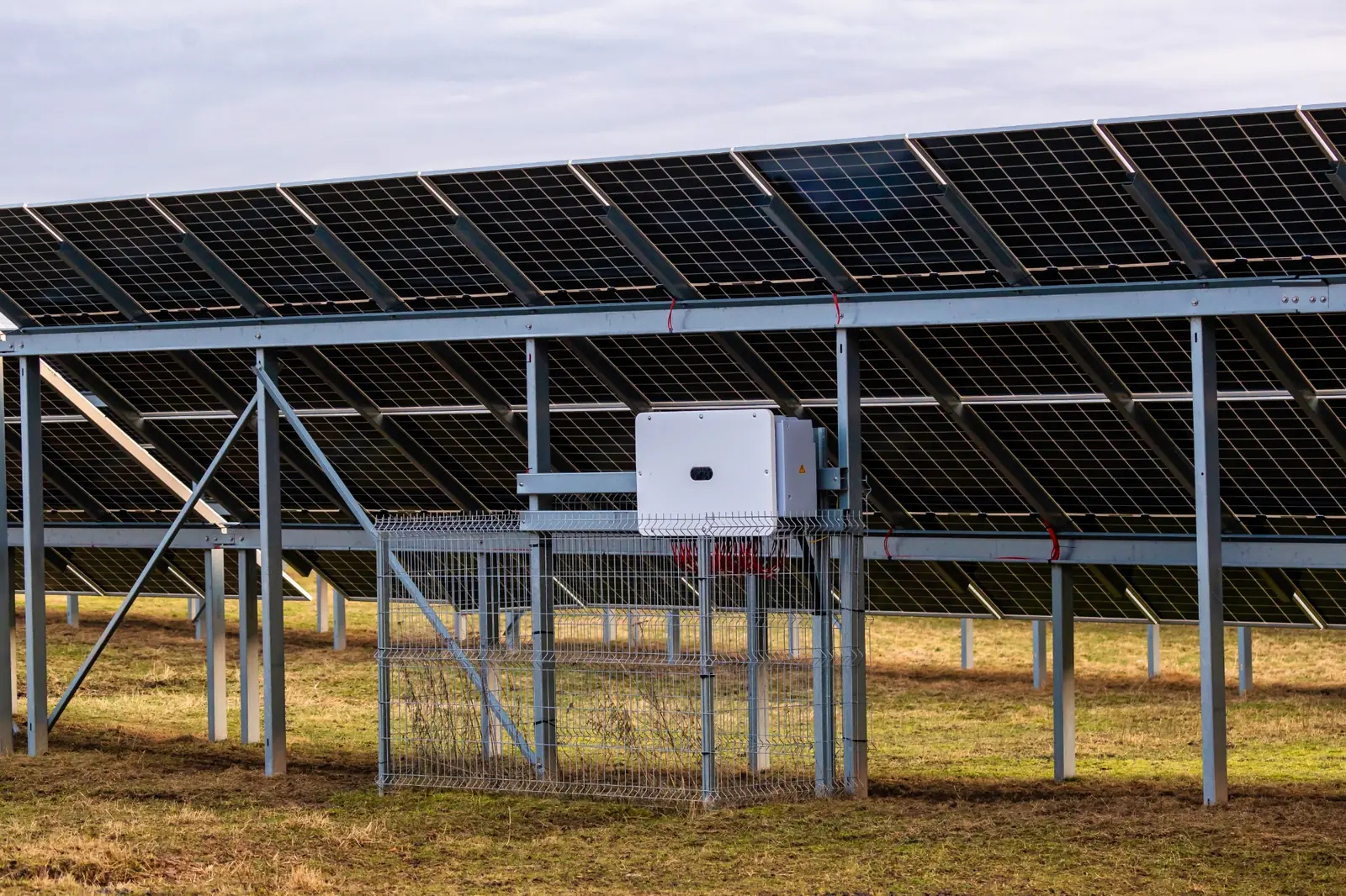 Ground-mounted solar panels with electrical equipment for large-scale plant integration