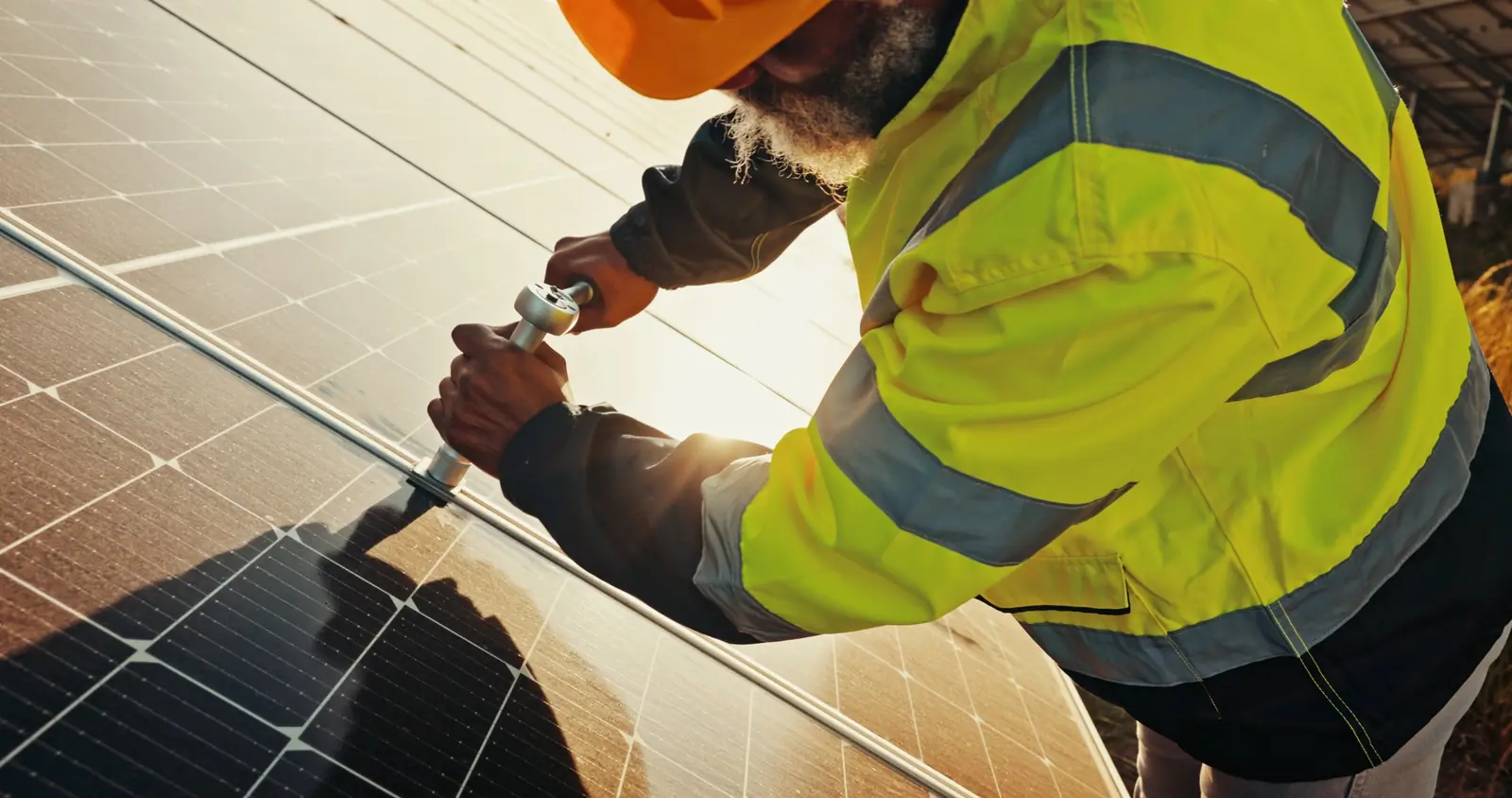 Solar technician applying safety and quality controls on a large photovoltaic installation