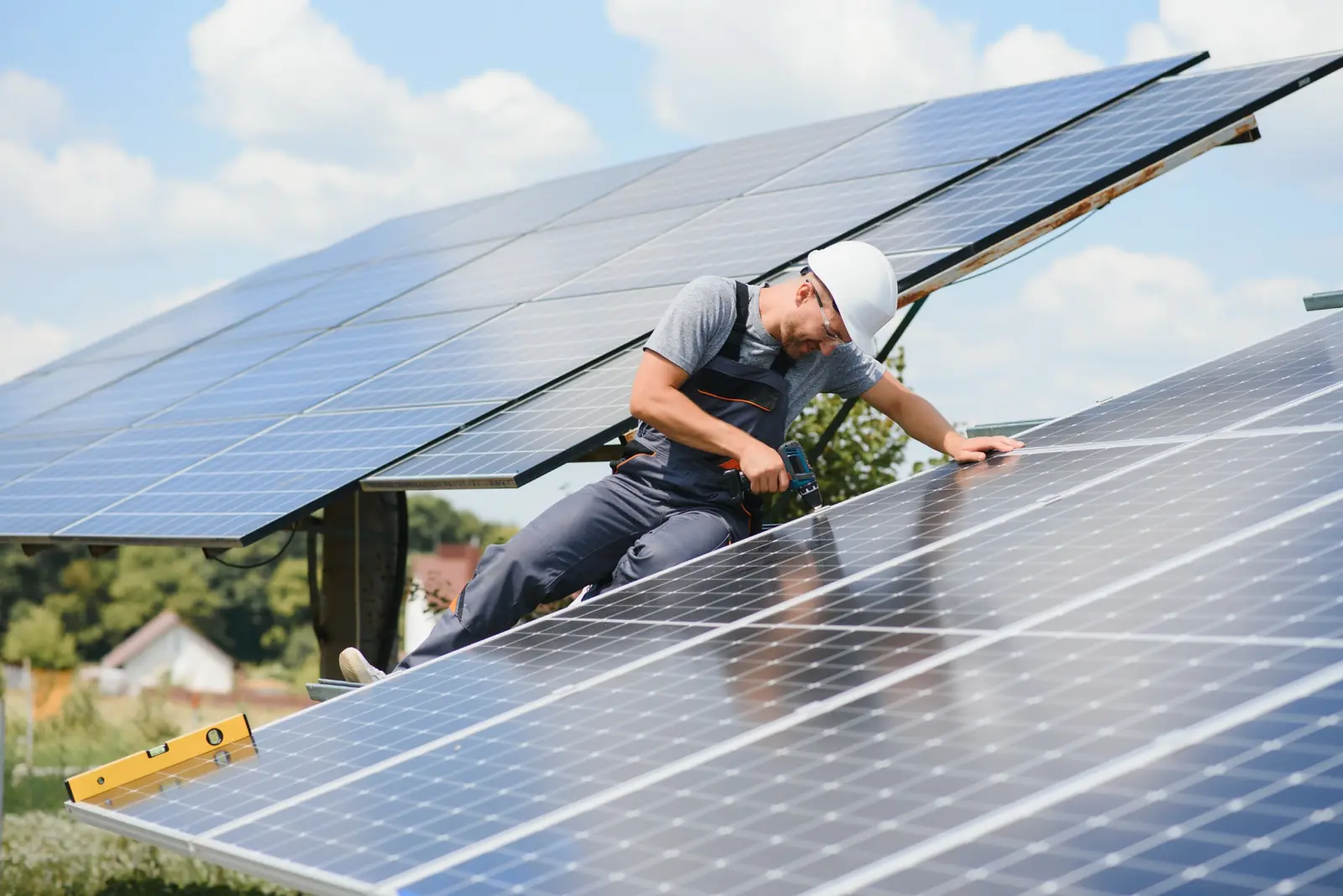 Technician inspecting photovoltaic panels during solar power plant commissioning