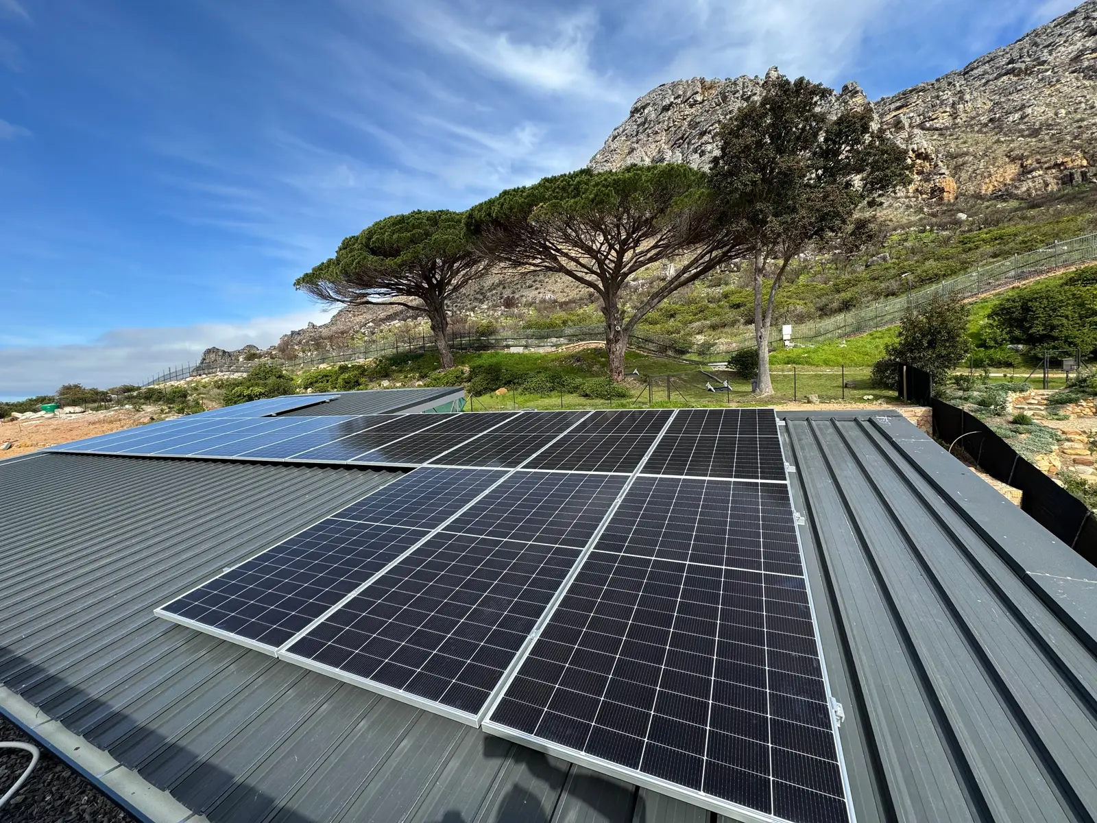 Completed rooftop solar installation beside mountain terrain in South Africa