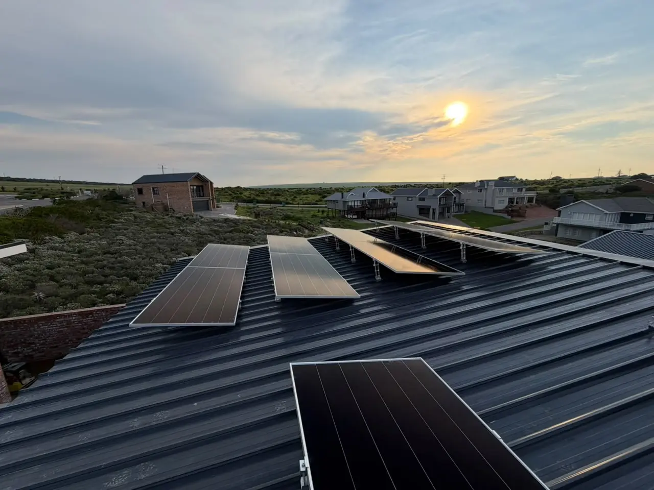 Rooftop solar photovoltaic array photographed at sunset