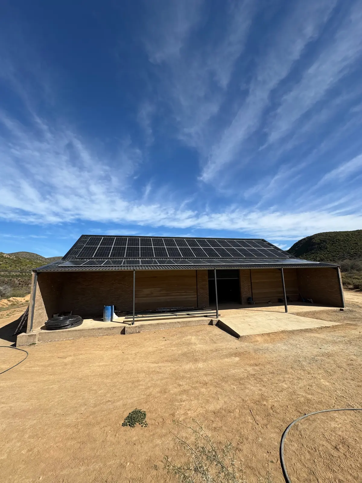 Rural agricultural workshop fitted with a rooftop solar photovoltaic system