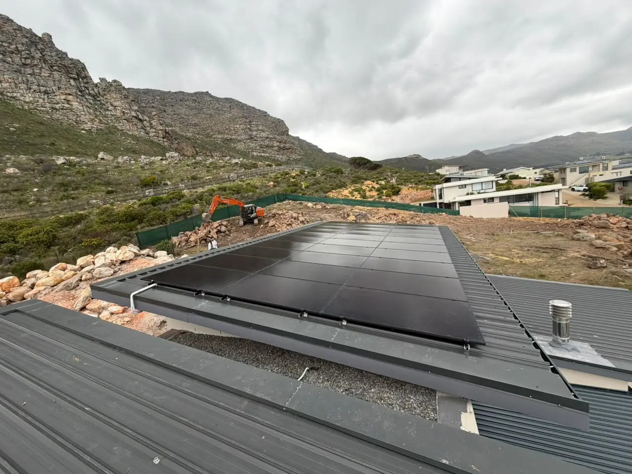 Solar panels integrated across a sloped commercial roof