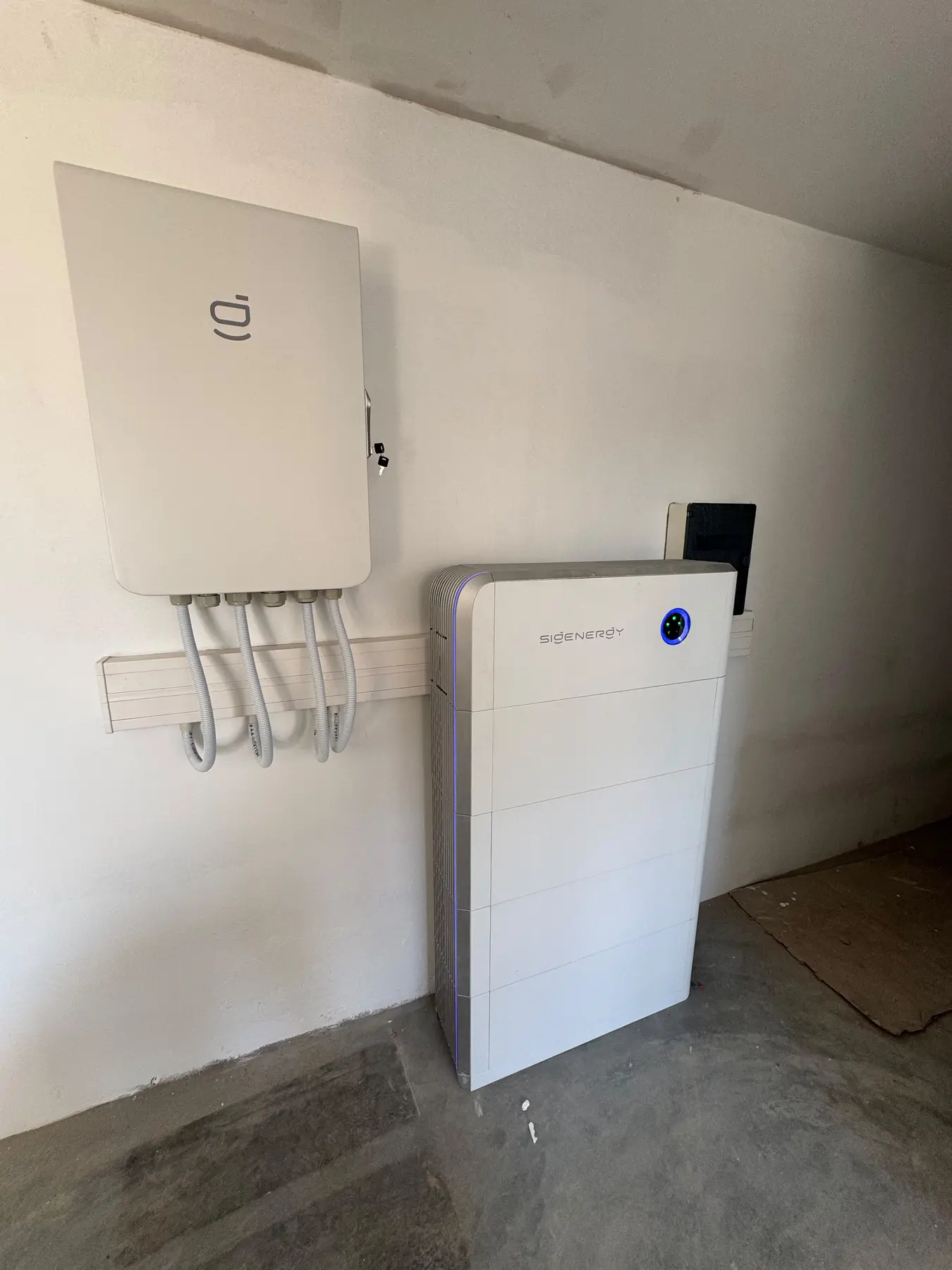 Residential Sigenergy inverter and battery storage system installed on a utility-room wall